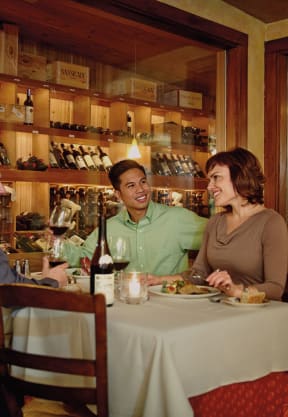 three people sitting at a table in a restaurant