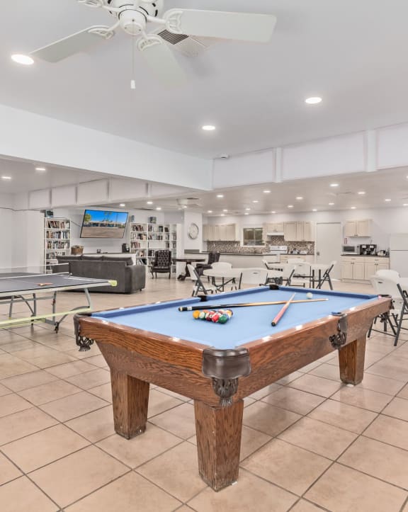 a recreation room with a pool table and ping pong