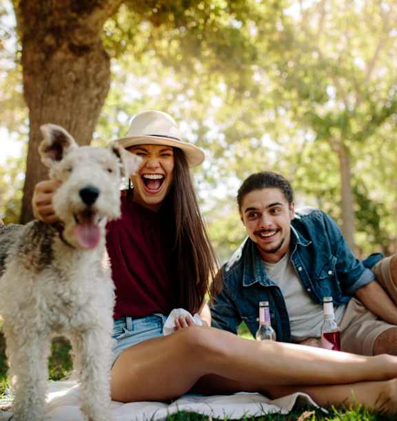 Two people with a dog outside