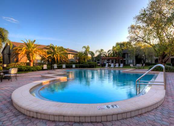 This is one of our three pools, with beautiful paver deck surrounded by lush landscaping.