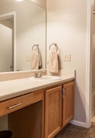 A bathroom with a white sink and a mirror.