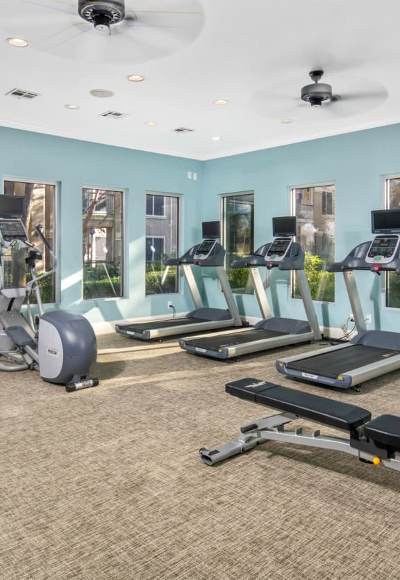 a gym with treadmills and other exercise equipment at The Park at Monterey Oaks, Austin, TX