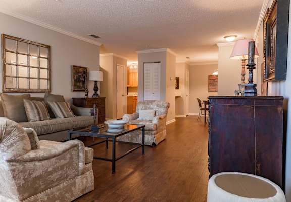 A living room with a couch, chair, and coffee table.