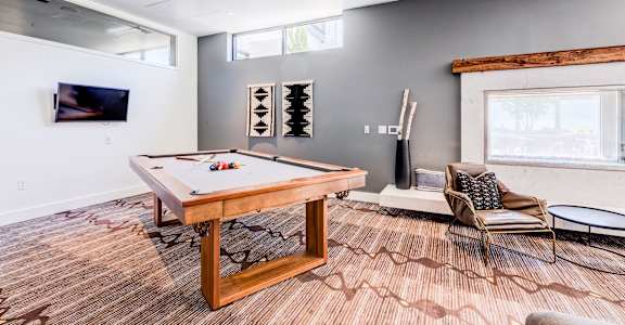 a game room with a pool table and a tv