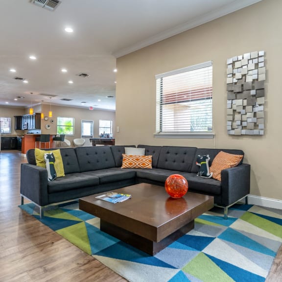 a living room with blue couches and chairs and a fireplace