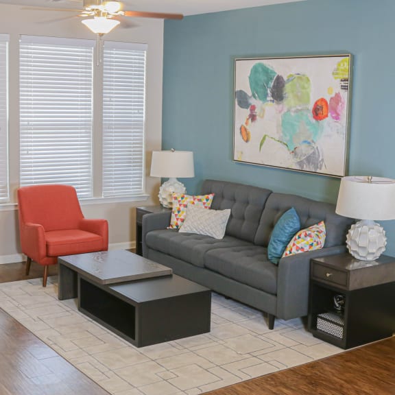 a living room with blue couches and chairs and a fireplace