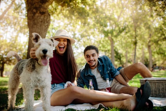 Two people with a dog outside