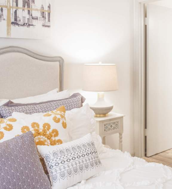 a bedroom with a bed with pillows and a closet