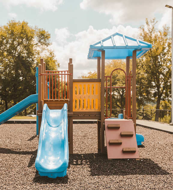 a playground with a swing set and a slide