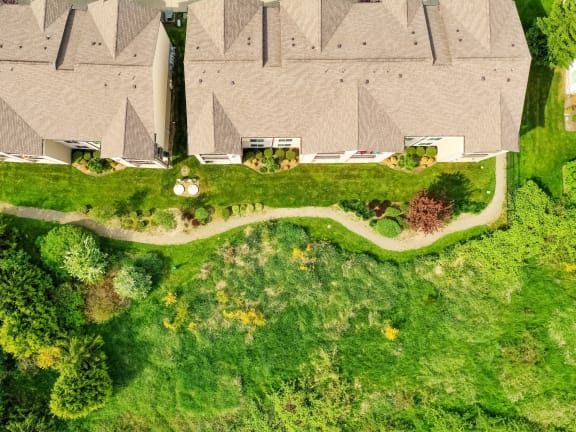 a house with a roof and a yard with green grass