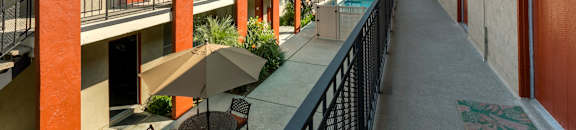 Apartments for Rent in Valley Village CA - Exterior View of Riverside Village Apartment Building in the Daylight Featuring Community Pool
