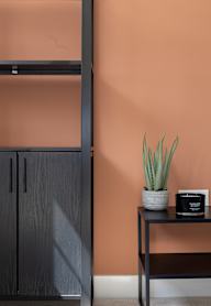 a bedroom with a bed and a nightstand with a lamp and a framed picture