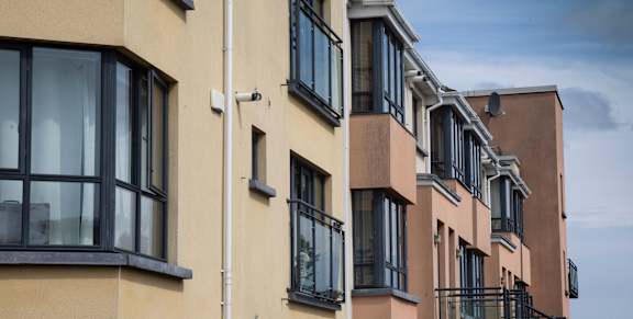 a row of apartment buildings with large windows and balconies