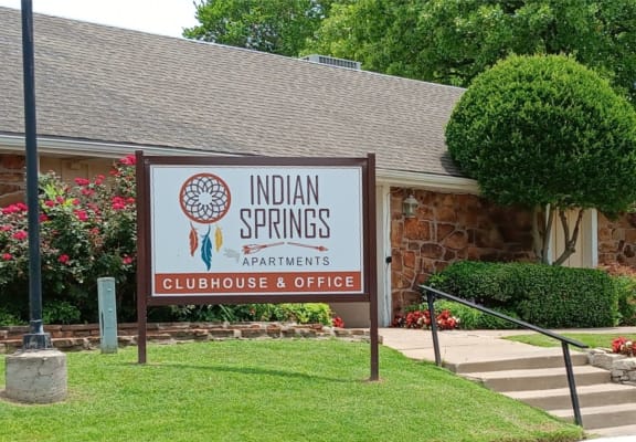 a building with a sign that says indian springs apartments