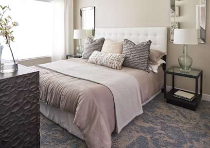 a bedroom with a bed and pillows at Linc, Des Moines, 50309