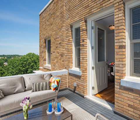 a balcony with a couch and a table