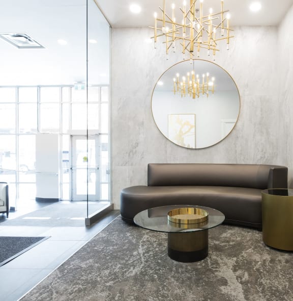 a living room with a round mirror and a couch