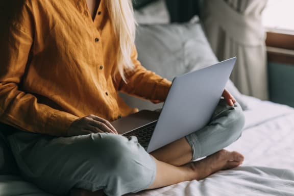 Woman Sitting with a Laptop at The Oxford Apartments, Oxon Hill 20745