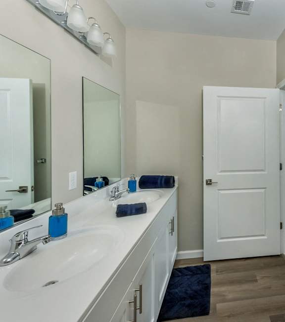 a bathroom with a shower and a sink and a mirror at Eden & Main 55+ Apartments, Southington , Connecticut