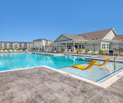 A large swimming pool with a slide in the middle of it.