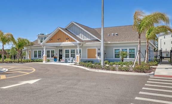A modern building with a parking lot in front.