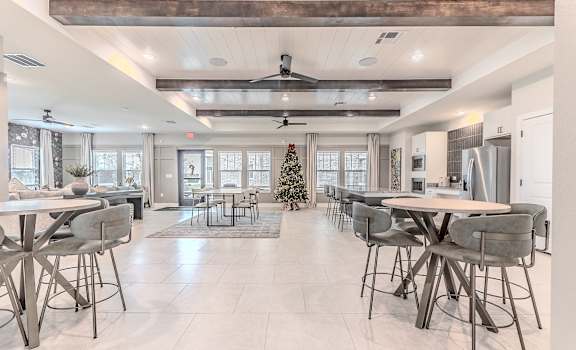 A modern dining room with a Christmas tree in the middle.