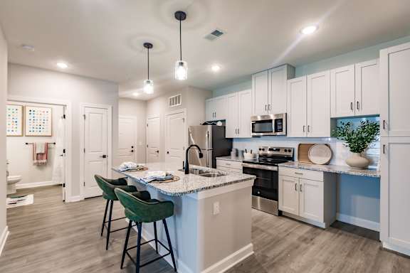 A kitchen with a white and blue color scheme.