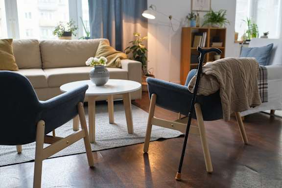 A living room with a sofa, two chairs, and a coffee table.