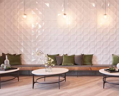 a seating area with tables and pillows at Linc, Iowa, 50309