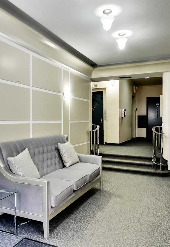 a living room with a couch and a glass table