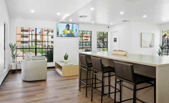 a living room with white walls and hardwood flooring