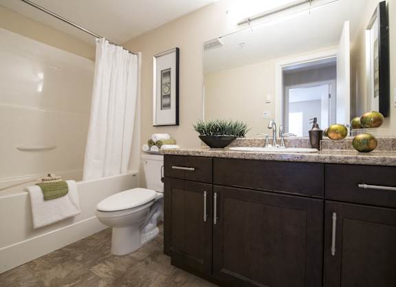 a bathroom with a toilet and a sink and a bath tub