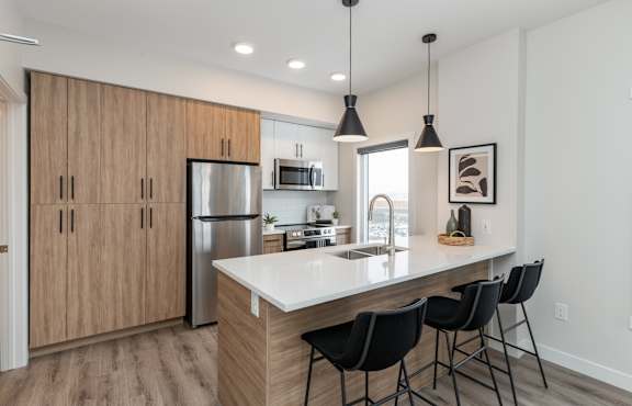 A modern dining room with a table set for four.