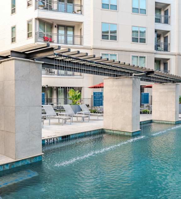A large swimming pool in front of a modern building.