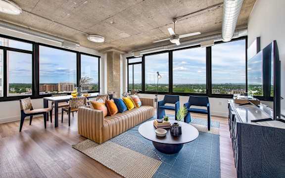 A living room with a couch, chairs, and a coffee table.