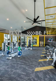a gym with treadmills and other exercise equipment in the lobby of a building