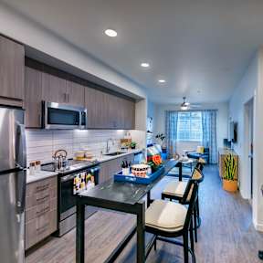 private kitchen with island and stainless steel appliances at the reserve at walnut creek apartments