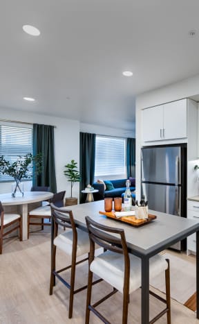 an open living room and kitchen with a table and chairs