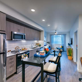 private kitchen with island and stainless steel appliances at the reserve at walnut creek apartments