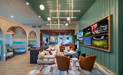 the lobby of a hotel with couches and tables and chairs