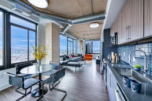a kitchen and living room with a large window overlooking a city