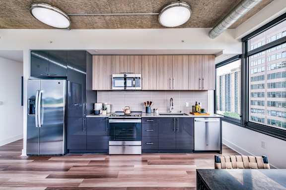 a kitchen with a stove and a sink next to a window