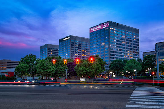 A city street at dusk with traffic lights and buildings.