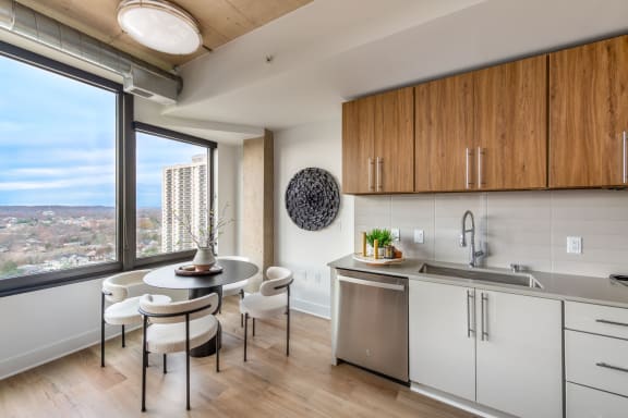 a kitchen with a large window and a table with chairs