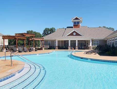 A large swimming pool in front of a building with a pergola at Ansley Walk, Lafayette, LA, 70503