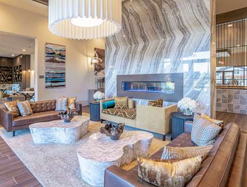 A living room with a brown couch and a white coffee table at Stone Loch Apartments, Tomball, Texas