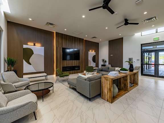 a large fitness room with cardio equipment and large windows