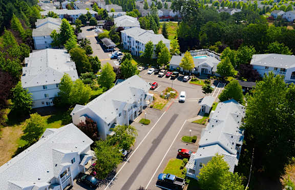 A bird's eye view of a residential area with houses and cars.