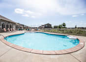 Thumbnail 4 of 9 - A round above ground pool with a concrete floor and wall.
