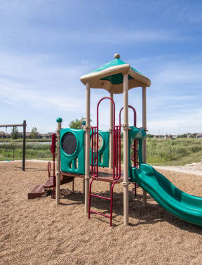 a playground with a slide and a swing set